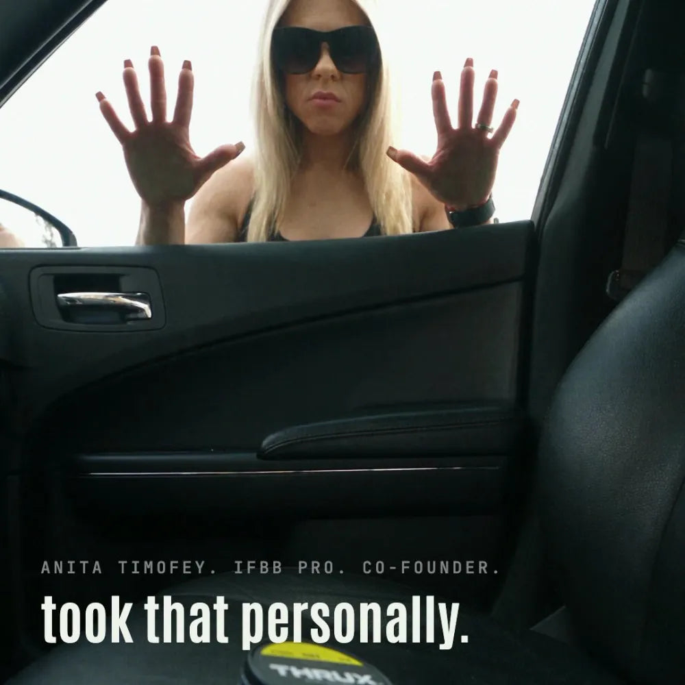 Anita Timofey, IFBB pro and THRUX co-founder, at the car window from the ad, with a THRUX can